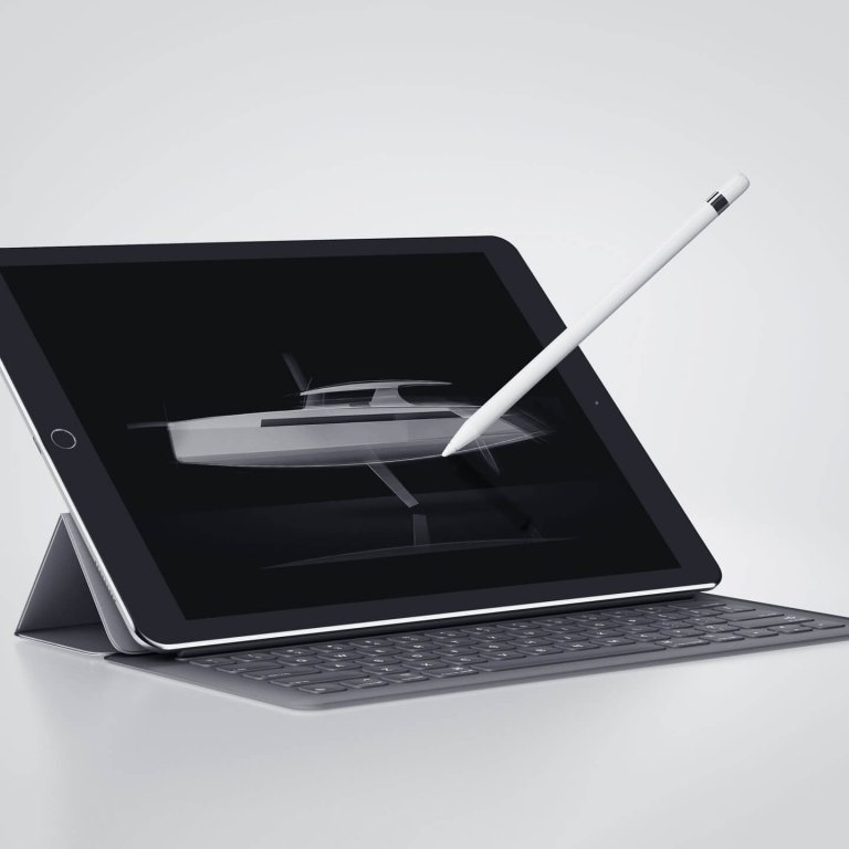 stylus poised over tablet making design drawings of a boat
