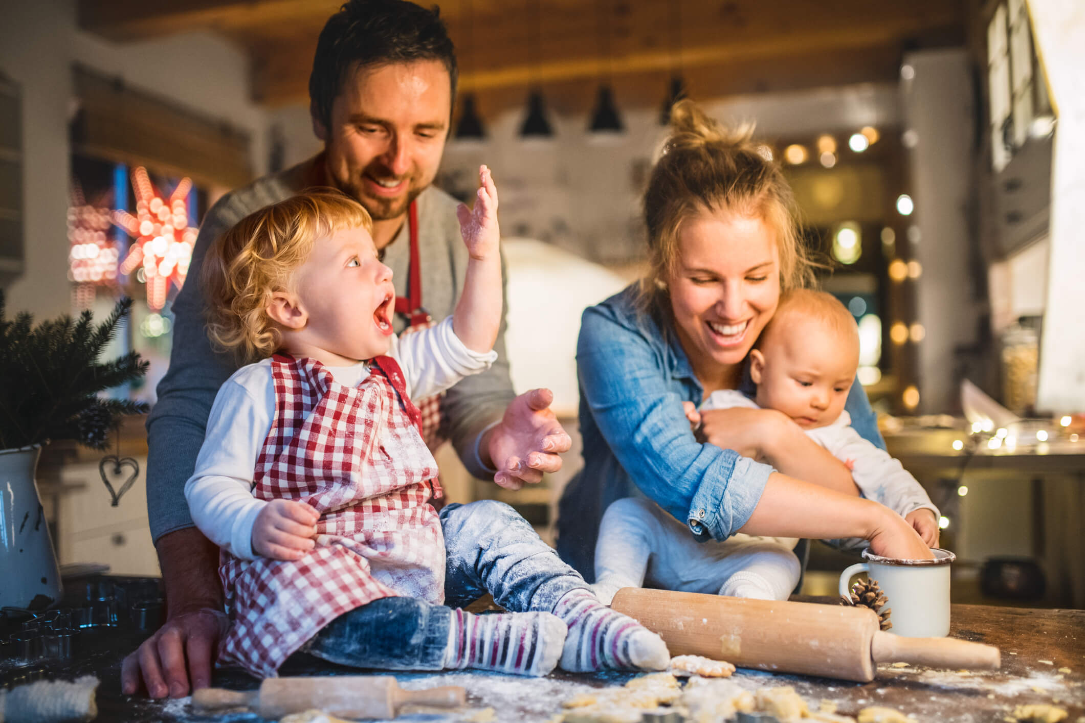 young family making christmas cookies together